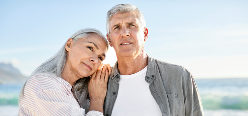 Mature man and female partner enjoying at beach